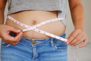 Woman Measuring Her Waistline for Visceral Adipose Tissue