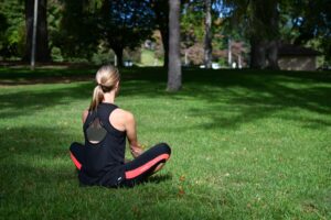 Strong female starting her day with yoga outside