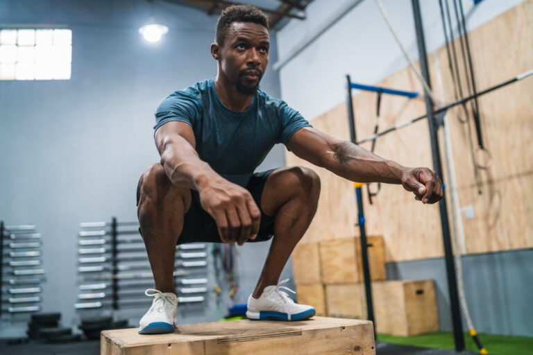 Man performing box jumps as part of concurrent training routine