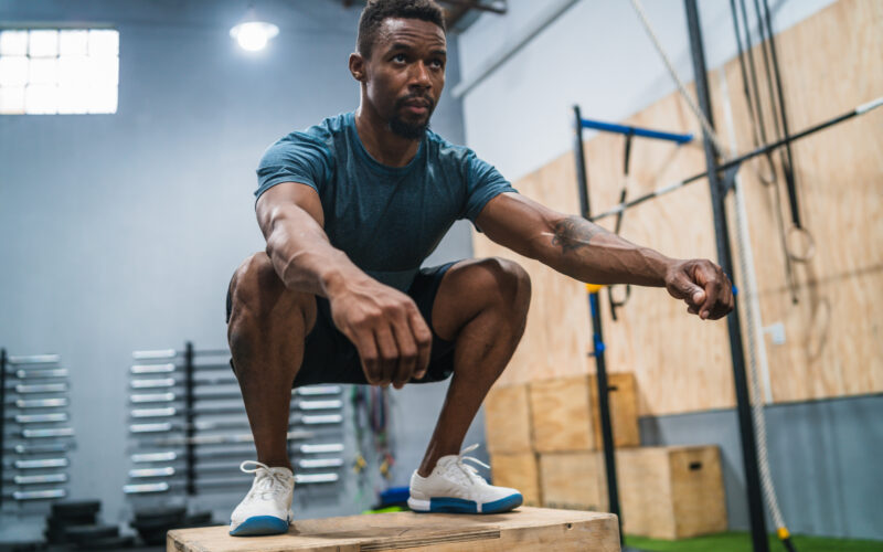 Man performing box jumps as part of concurrent training routine