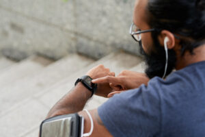 athlete looking t heart rate on wrist monitor