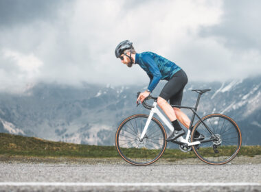 Cyclist climbing a steep hill, symbolizing the challenge and performance aspect of cycling