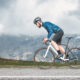 Cyclist climbing a steep hill, symbolizing the challenge and performance aspect of cycling